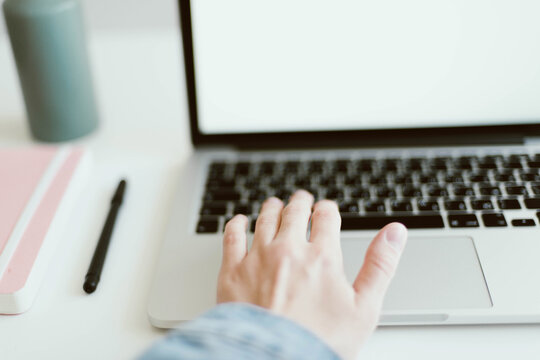 Woman typing at white desk