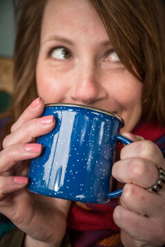 Woman Sips Coffee On Montana Ranch Porch.