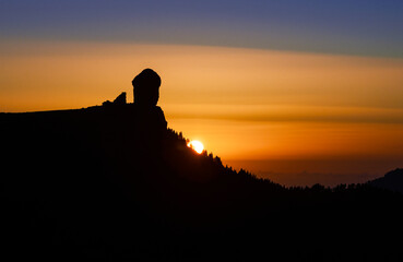 The sun going down over the Roque Nublo silhouette, Roque Nublo Rural Park, Gran Canary, Canary Islands, Spain