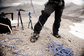 A mountaineer prepares his gear before embarking up Mount Trident (1832m) including a glacial traverse, Valley of Ten Thousand Smokes, Katmai National Park, Alaska.