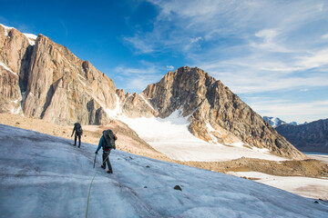 Climbers cross a glacier in Akshayak Pass, Baffin Island