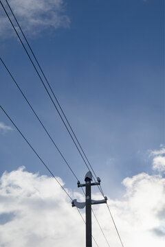 Low angle view of snow on electricity pylon against sky