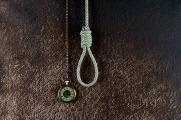 Fototapeta na wymiar Vintage Pocket Watch and Hangmans Noose on a Mottled Background