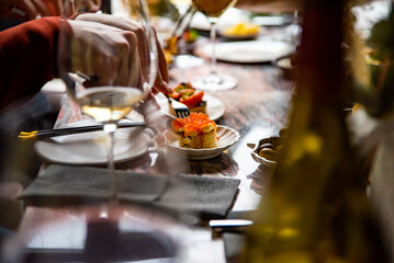 man eat Canape with brioche, butter, salmon red caviar.