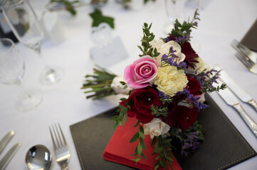 Wedding bouquet of flowers on reception table ready for evening meal and party