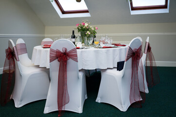 Wedding bouquet of flowers on reception table ready for evening meal and party