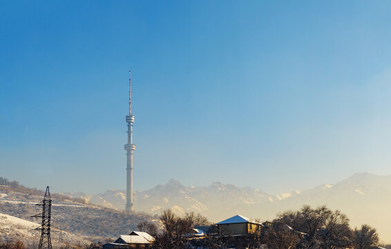 Almaty Television Tower and mountain view during winter smog.  Kazakhstan