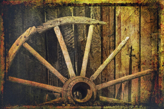 Simulated old victorian photograph of a broken down old wagon wheel against a barn 