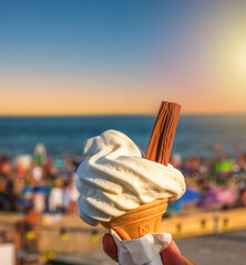 Ice cream cone held up to the hot summer sky in Bournemouth, England	