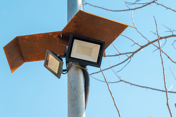 Solar powered led spotlight mounted on the outer wall of the warehouse