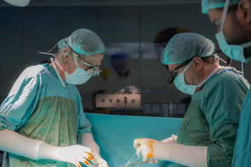 Open heart surgery, doctors and cardiologists perform open heart surgery. Doctors in green uniforms...