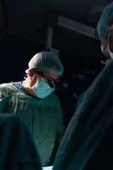 Open heart surgery, doctors and cardiologists perform open heart surgery. Doctors in green uniforms in the operating room.