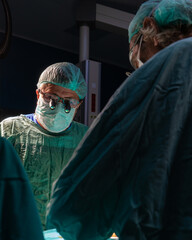 Open heart surgery, doctors and cardiologists perform open heart surgery. Doctors in green uniforms...