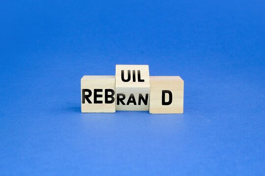 wooden cube with the words rebrand and rebuild. business rebuild and rebrand concept.