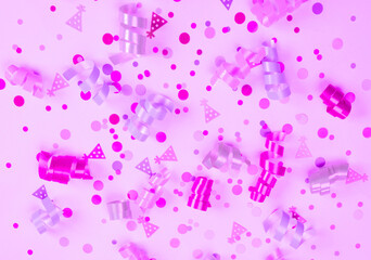 Festive purple or pink background with serpentine ribbons, confetti, party concept, children's girls birthday