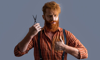 barber bearded man at barbershop, thumb up. photo of barber bearded man hold barbershop scissors