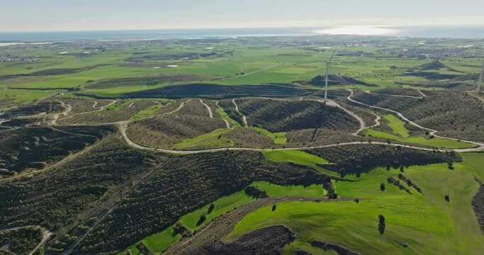 Aerial view of a lonely windmill on the seashore. Production of green electricity. Ecological wind energy. High quality 4k footage