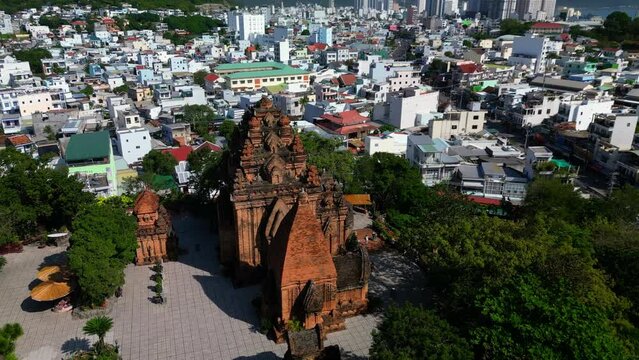Tower against the backdrop of tall pagoda and blue sky. Aerial view of the Ponagar Tower on Mount La Lao of Vietnam is one of Vietnam landmarks in Nha Trang. Tourists take pictures on backdrop Ponagar