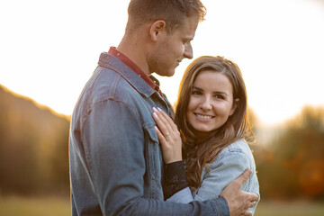 Fototapeta premium Happy partners on a getaway kissing, smiling and relaxing outdoors enjoying and loving the sunlight