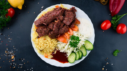 Beef with rice, tomatoes, cabbage salad, cucumbers, ketchup and mayonnaise.