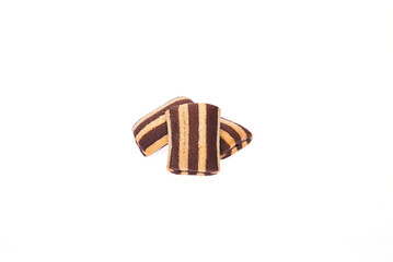 Three cookies partially covered with icing on a clean white isolated background.
