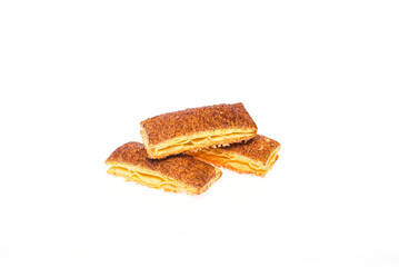 Three cookies partially covered with icing on a clean white isolated background.