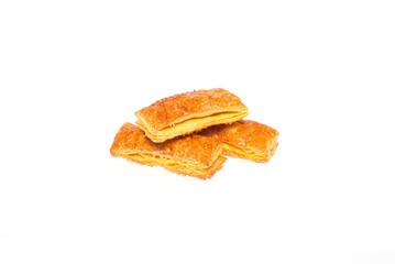 Three cookies partially covered with icing on a clean white isolated background.