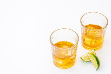Golden whiskey in glass with ice. Strong alcohol background