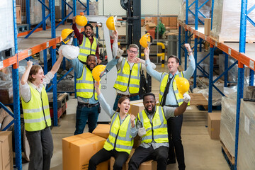 Raised angle portrait group photo of workers inside a food distribution warehouse