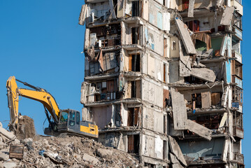 construction equipment destroys houses damaged during the war in Ukraine