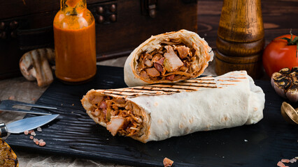 Fresh grilled shawarma with ham, pork, cabbage, sauce and pita bread.