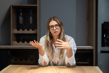 Young woman talking on video call with her psychotherapist doctor after online therapy sessions,...