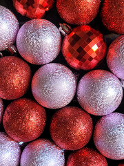 Banner with colorful christmas balls on black concrete background. Colorful xmas backdrop with viva magenta ball. 