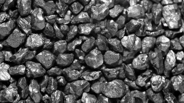 Black stones moving. Close-up of a black stones surface moving.