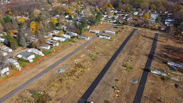 Aerial View Construction Site Of Mobile Trailer Park Near Complete Manufactured Houses Colorful Fall Foliage In Rochester, New York