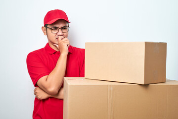Concerned and troubled asian courier in red uniform and cap grab head and gasping shocked staring...
