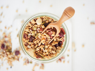 Jar with healthy granola and spoon