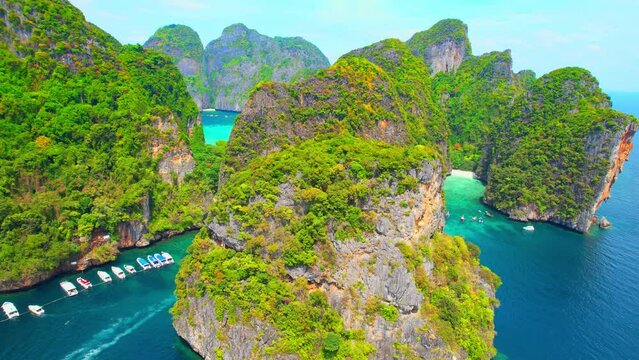 Drones fly over limestone mountain islands and beautiful bays, .Maya bay, Phi phi island, Krabi, Thailand. One of the most beautiful tropical seas in the world. Vacation and relaxation concept. 4K
