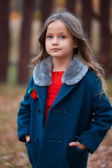 An attractive little girl model with makeup in autumn. Trends and blogs in autumn