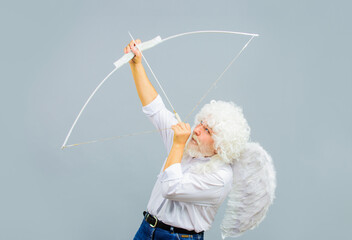 Male angel aiming up with bow and arrow. February 14. Saint Valentines Day. Arrows of love. Cupid.