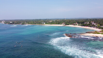 Fototapeta premium Sri Lanka Southern beaches captured by a drone. Indian blue ocean with clear blue sky, warm tropical temperature, 