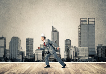 King businessman in elegant suit running and drawn cityscape silhouette at background