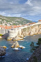 Dubrovnik West Harbor and view to the ancient city wall on the rocks, Dubrovnik, Croatia
