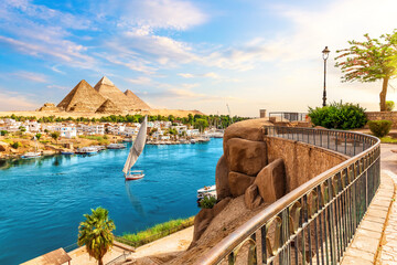 Skyline view of Aswan with sailboats in the Nile on the way to pyramids, Egypt
