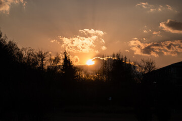 Obraz premium Silhouette sunset with sunlight flare at a countryside town