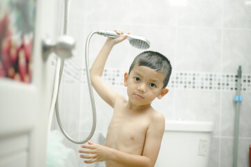 Happy little boy washing head in shower in the bathroom,Happy boy singer under the shower at home,Little Boy Taking Shower With Soap p and shampoo.