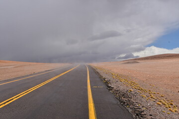 Loneley road in desert with Clouds yellow stripe Chile