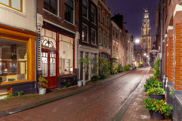 Fototapeta na wymiar Night street in Amsterdam against the background of the Westerkerk tower.