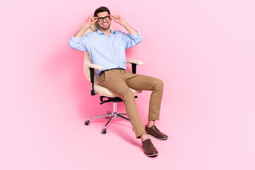 Full length photo of confident successful man psychologist sit comfort chair interview vacancy empty space isolated pink color background