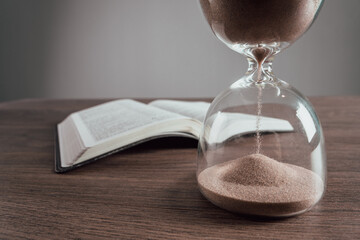 Hourglass and open book